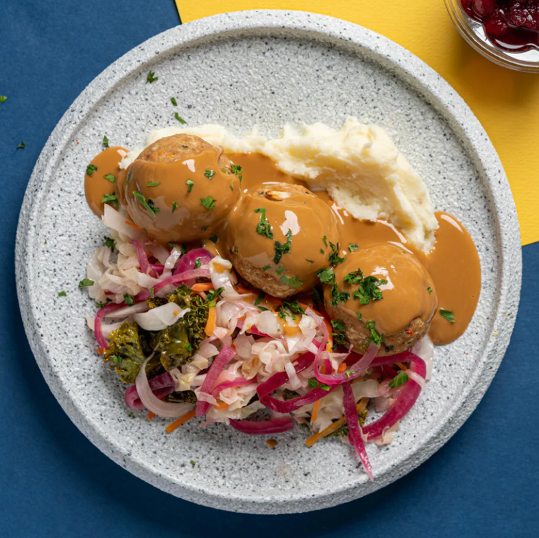 Swedish plant based Pork Meatballs with Braised Cabbge, Baby Kai Lan & Lingonberry Compote and Mashed Potatoes