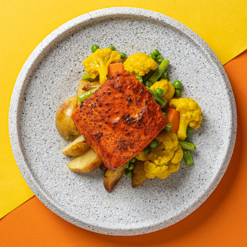 Tandoori Marinated Salmon with Steamed Market Vegetables, Turmeric Cauliflower, Tomato Cucumber Raita & Vegetable Biryani