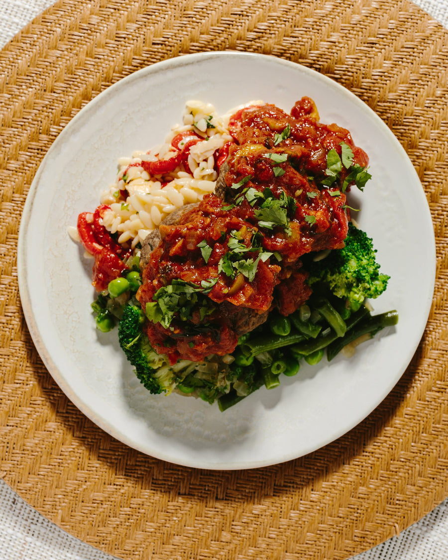 Mushroom Meatballs in Spanish Olive Tomato Sauce with Sauteed Greens & Orzo Salad